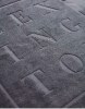 Tapis de bain avec logo embossé en relief éponge uni
